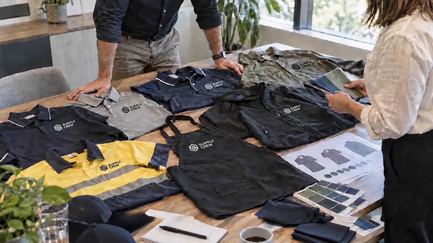 Supply Crew custom branded apparel laid out on table