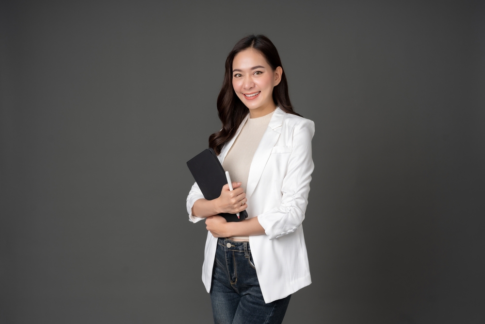 A woman employee wearing a white coat for a  business meeting